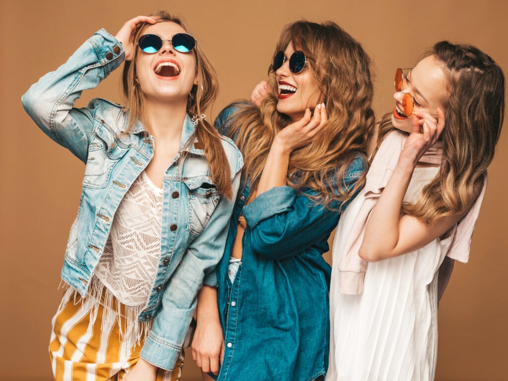 three young beautiful smiling girls trendy summer casual jeans clothes sexy carefree women posing positive models sunglasses