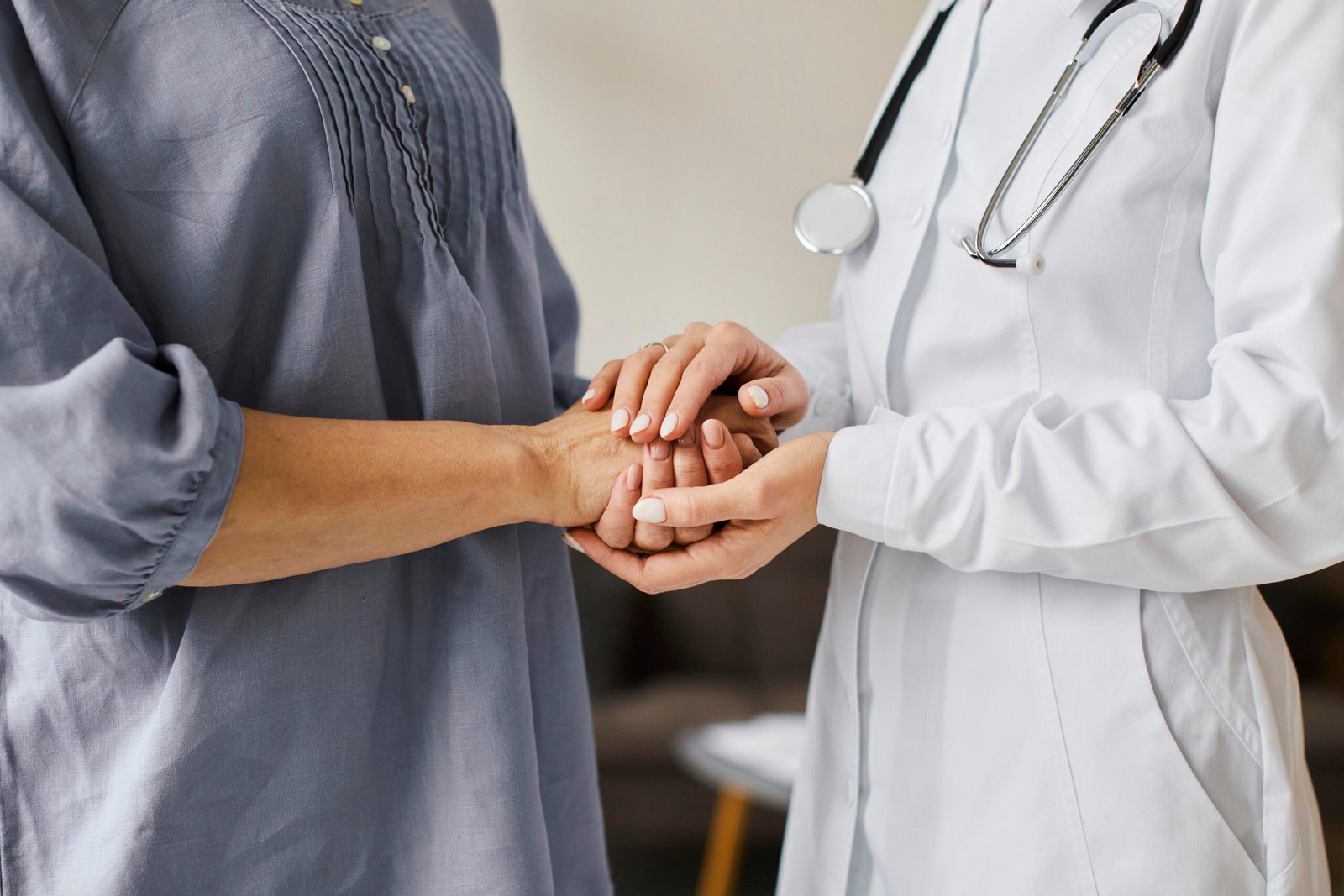 covid recovery center female doctor holding older patient s hands scaled